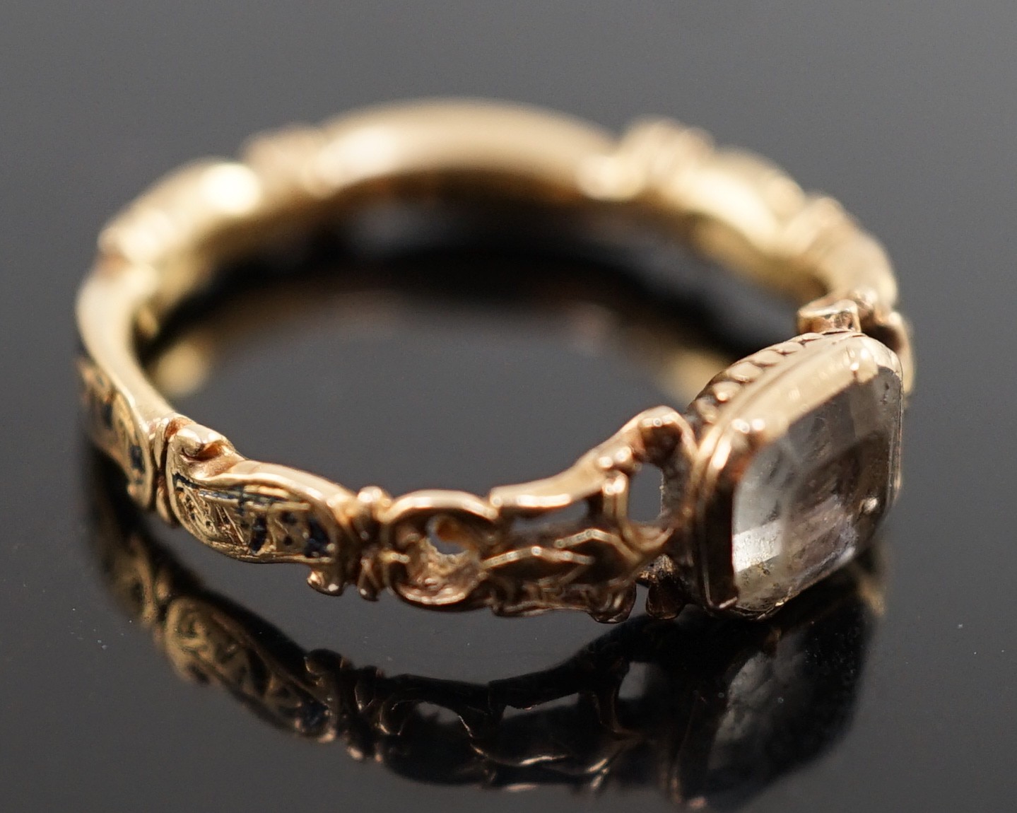 A George II gold, black enamel and rock crystal set mourning ring
